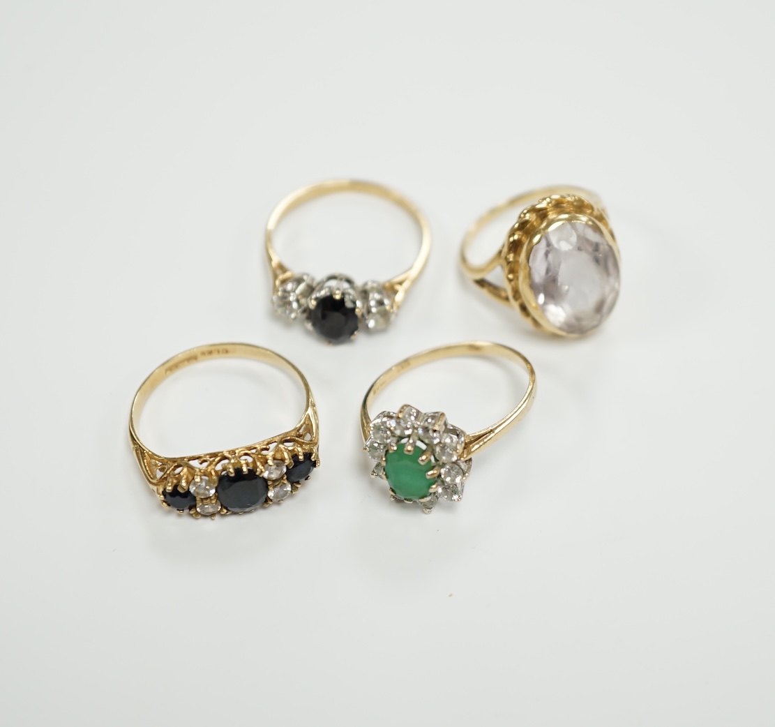 Four assorted modern 9ct gold and gem set dress rings, including sapphire and simulated diamond, gross weight 9.9 grams.